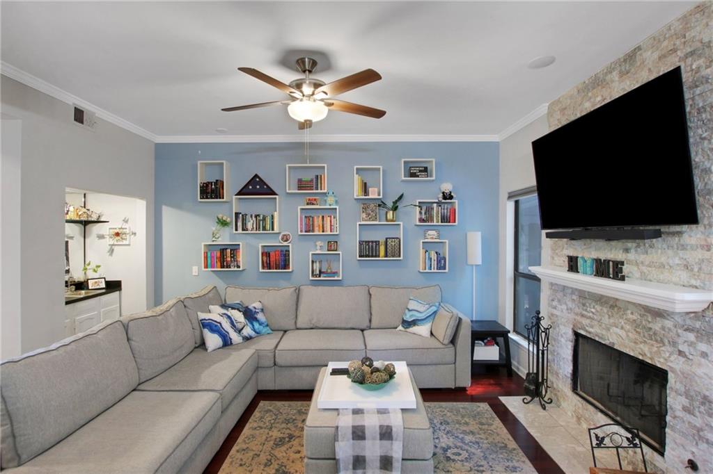 1929 Variations Drive Northeast Atlanta, GA 30329 - Photo 6 of 33 a living room with furniture a flat screen tv and a fireplace