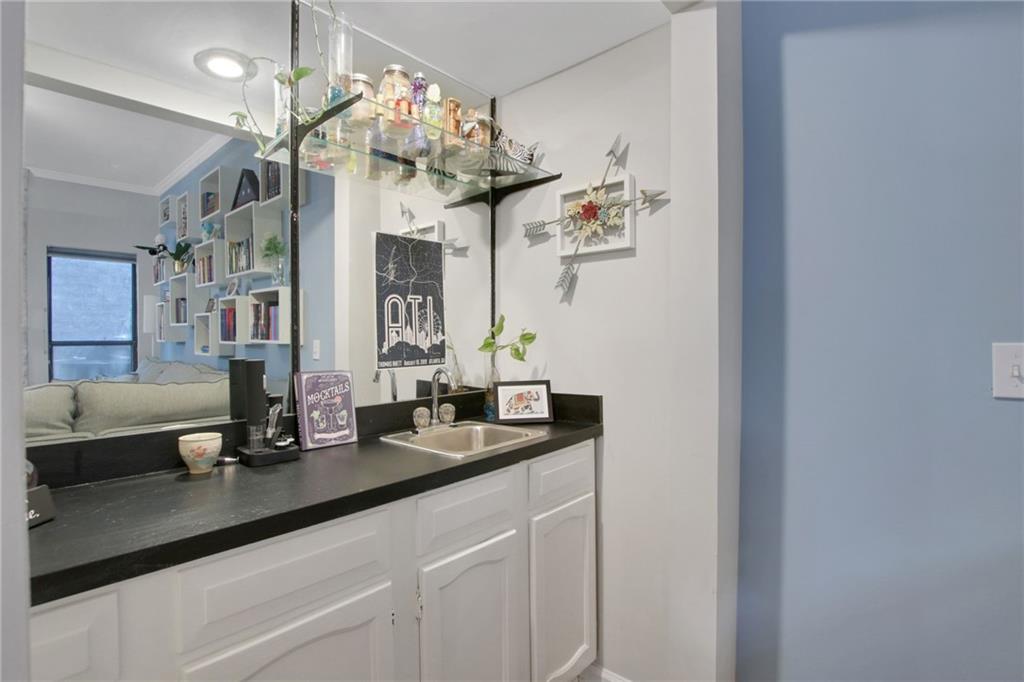 1929 Variations Drive Northeast Atlanta, GA 30329 - Photo 10 of 33 a bathroom with a granite countertop sink a large mirror and a shower