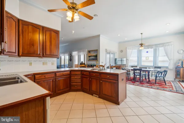 a kitchen with stainless steel appliances granite countertop a sink a stove counter space and cabinets