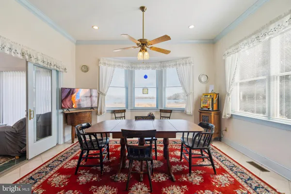 a view of a a dining room with furniture window and wooden floor