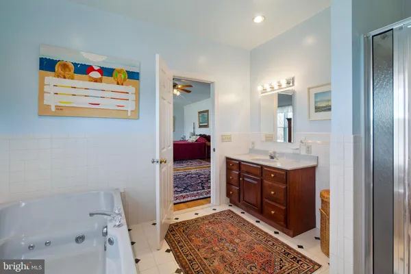 a bathroom with a sink mirror and shower