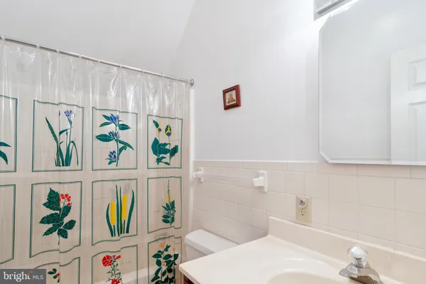 a bathroom with a refrigerator and a sink