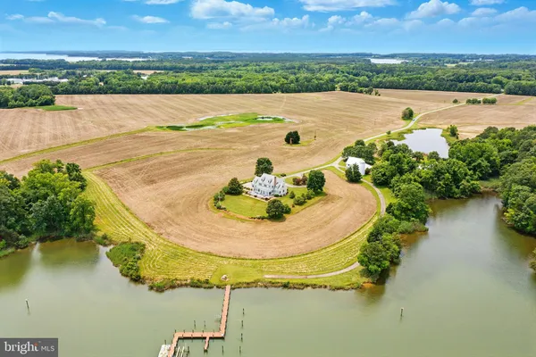 an aerial view of a house with outdoor space and lake view