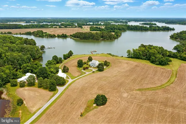 an aerial view of a house with outdoor space and lake view