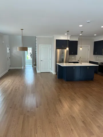 a view of kitchen and kitchen with furniture wooden floor and window