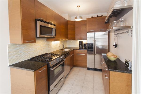 8 Chiswick Road, Unit 27 Boston, MA 02135 - Photo 2 of 9 a kitchen with a stove a microwave and refrigerator