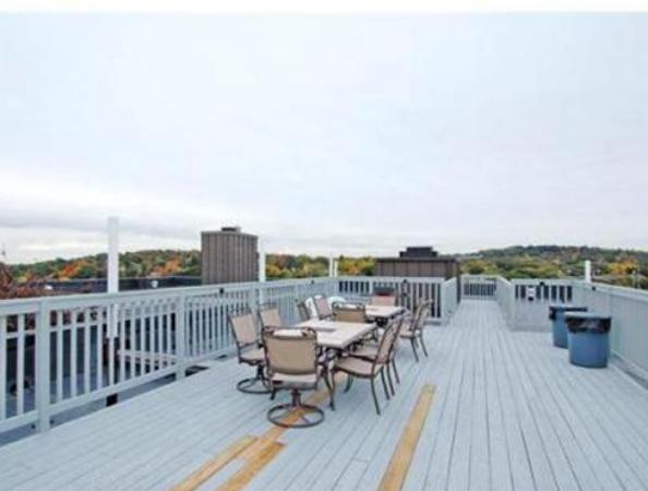8 Chiswick Road, Unit 27 Boston, MA 02135 - Photo 8 of 9 a view of a terrace with wooden benches and city view