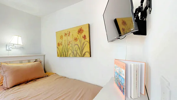 a bedroom with a bed and a window