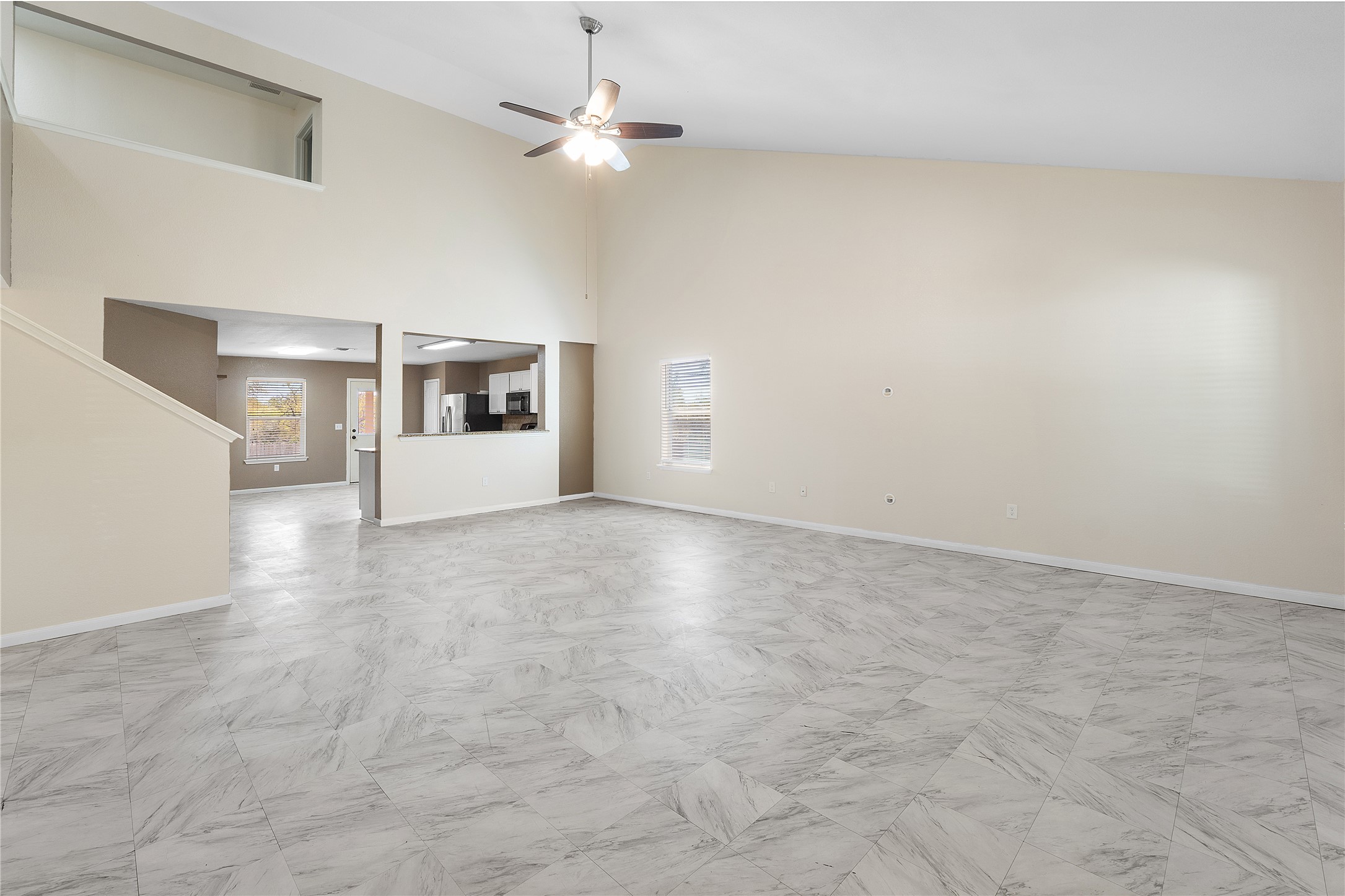 18436 Weatherby Lane Elgin, TX 78621 - Photo 2 of 23 Unfurnished living room featuring high vaulted ceiling and a ceiling fan