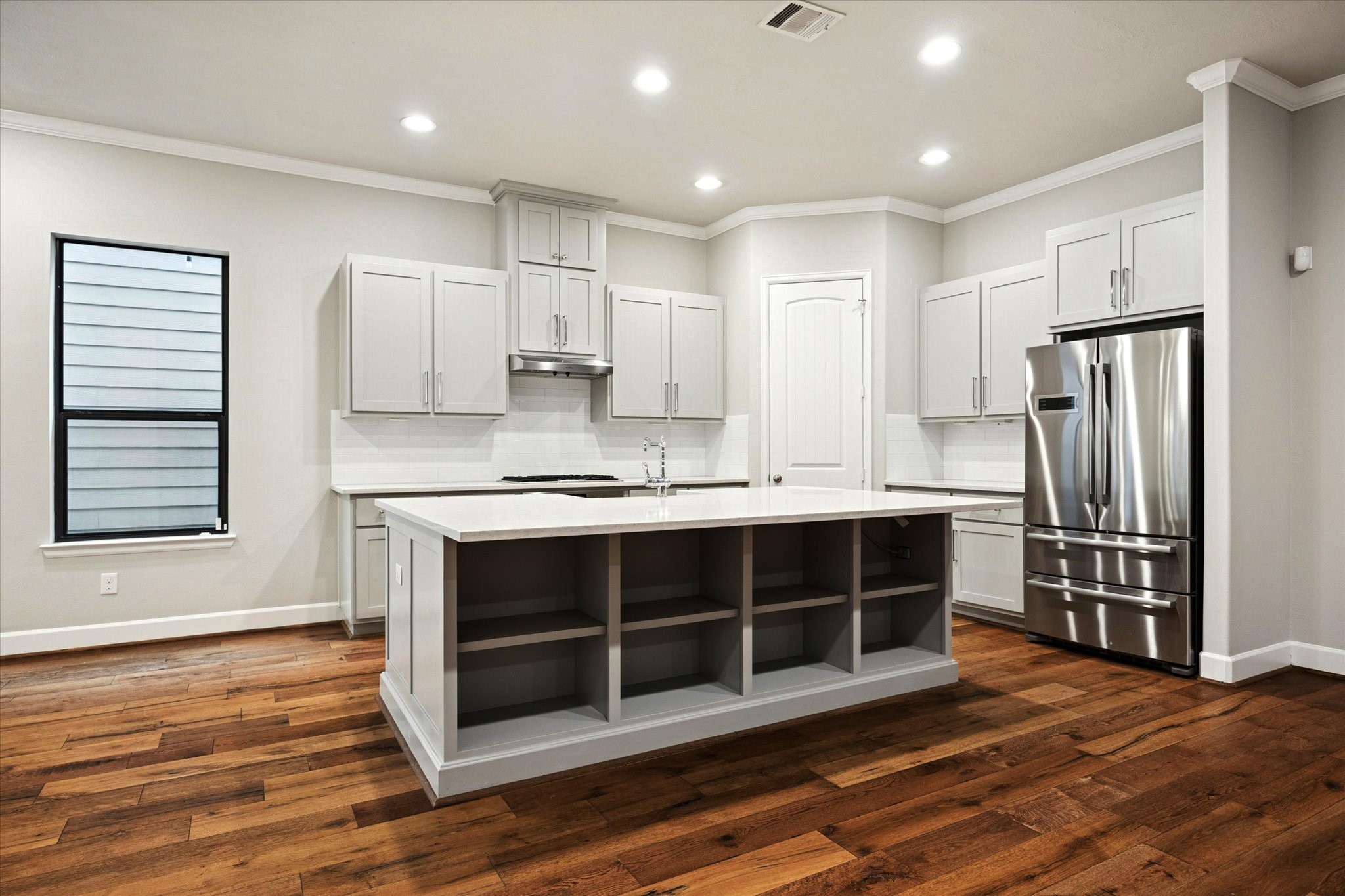 4014 Woodhead Street Houston, TX 77098 - Photo 14 of 37 a kitchen with stainless steel appliances a refrigerator and a stove top oven