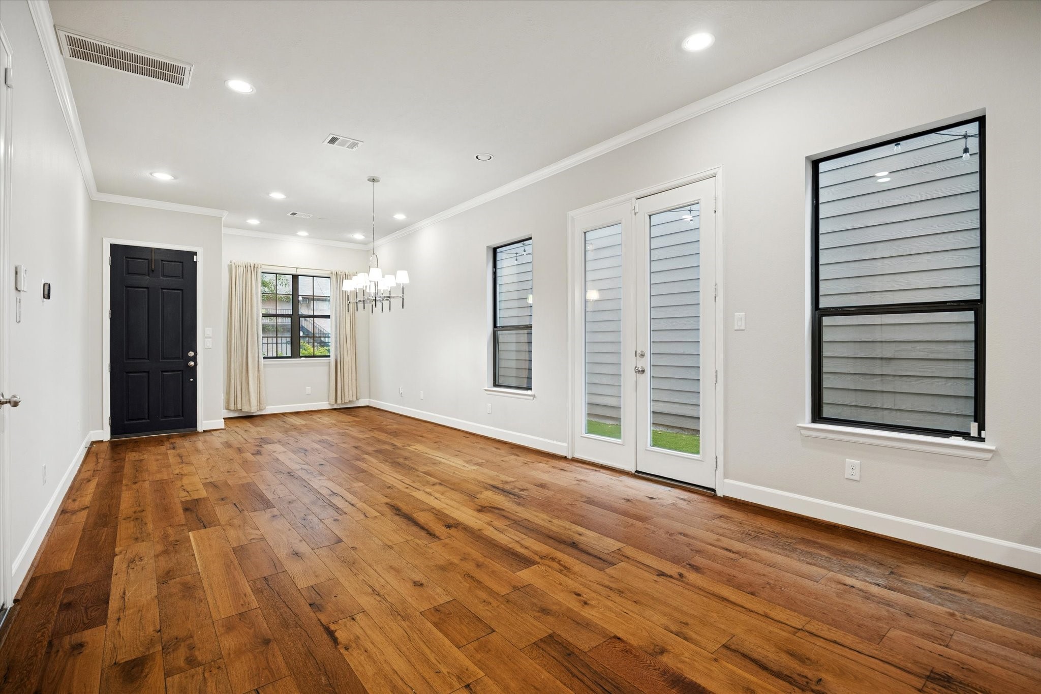 4014 Woodhead Street Houston, TX 77098 - Photo 7 of 37 a view of an empty room with wooden floor and a window
