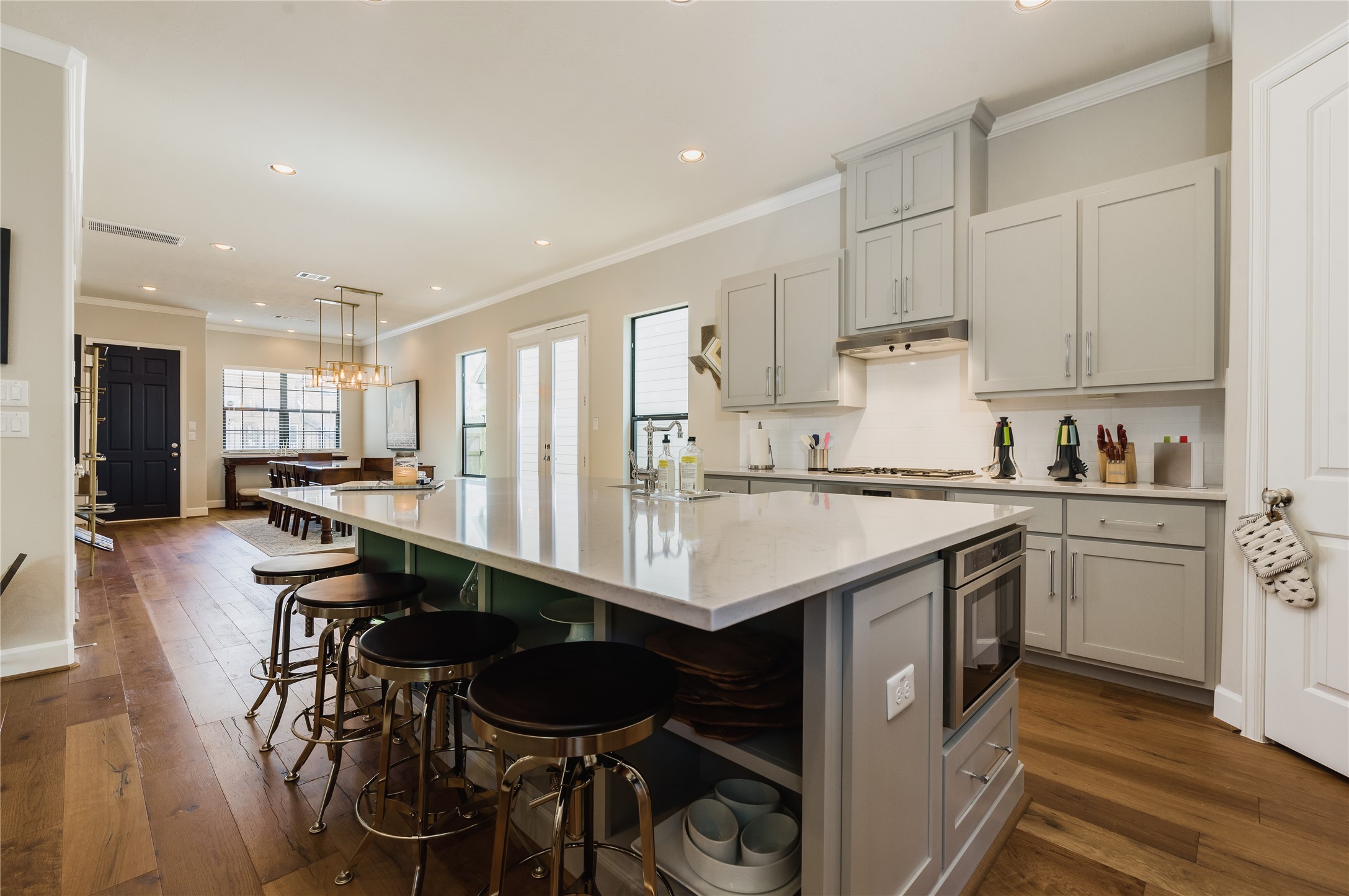4014 Woodhead Street Houston, TX 77098 - Photo 10 of 37 a kitchen with granite countertop a table chairs stove and cabinets