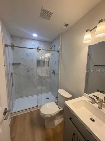 a bathroom with a sink toilet and shower