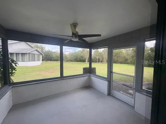 wooden floor in an empty room with a large window