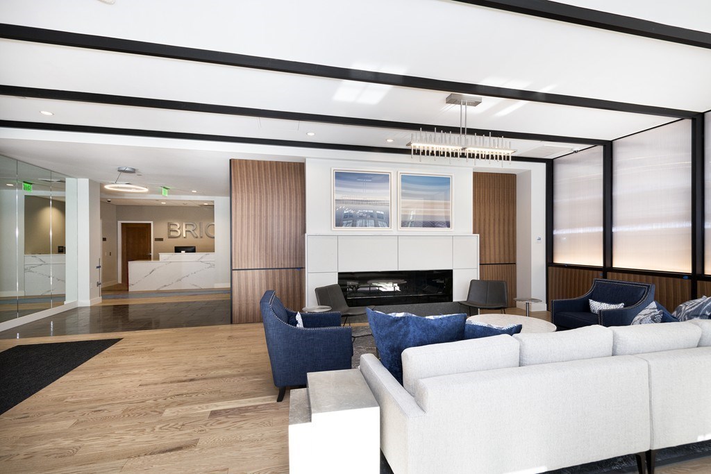 10 Shipyard Drive, Unit 517 Hingham, MA 02043 - Photo 12 of 14 a living room with furniture a fireplace and a flat screen tv