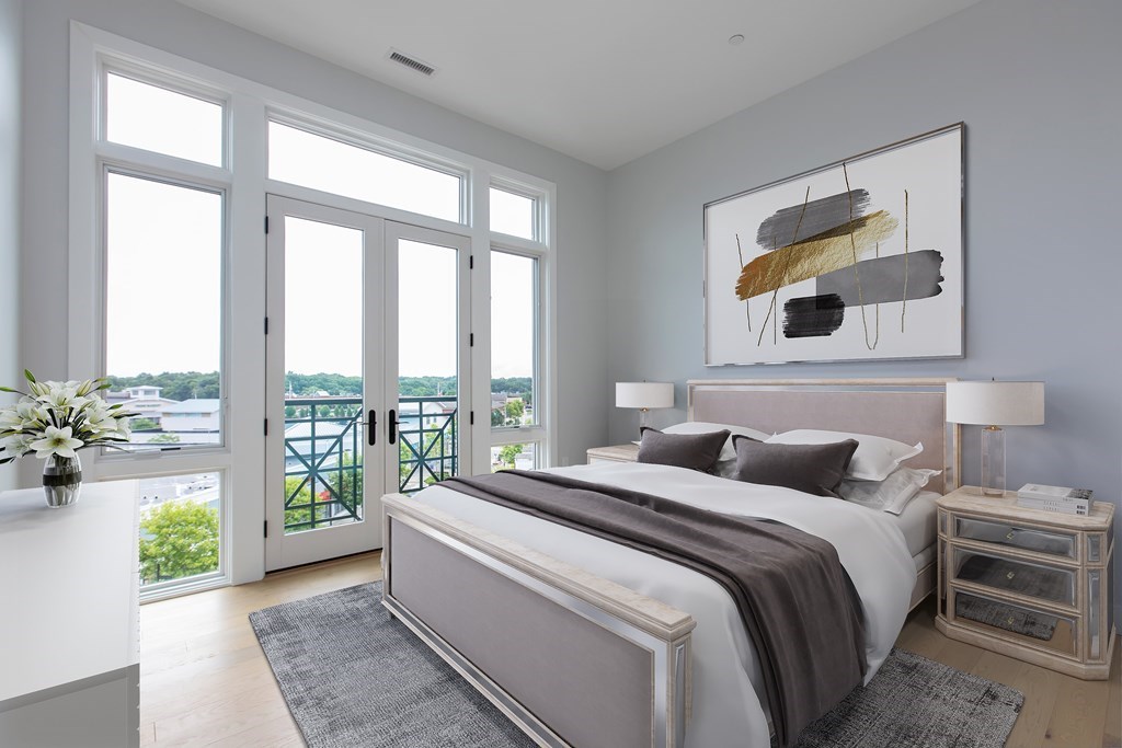 10 Shipyard Drive, Unit 517 Hingham, MA 02043 - Photo 2 of 14 a bedroom with a balcony a bed and a couch