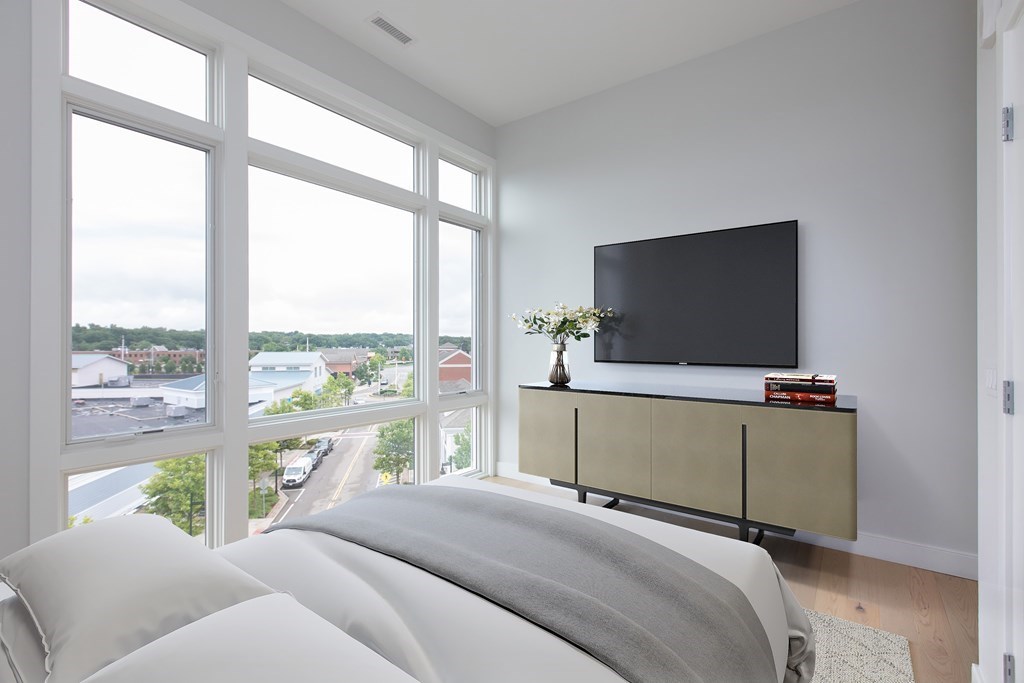 10 Shipyard Drive, Unit 517 Hingham, MA 02043 - Photo 3 of 14 a bedroom with a bed and flat screen tv