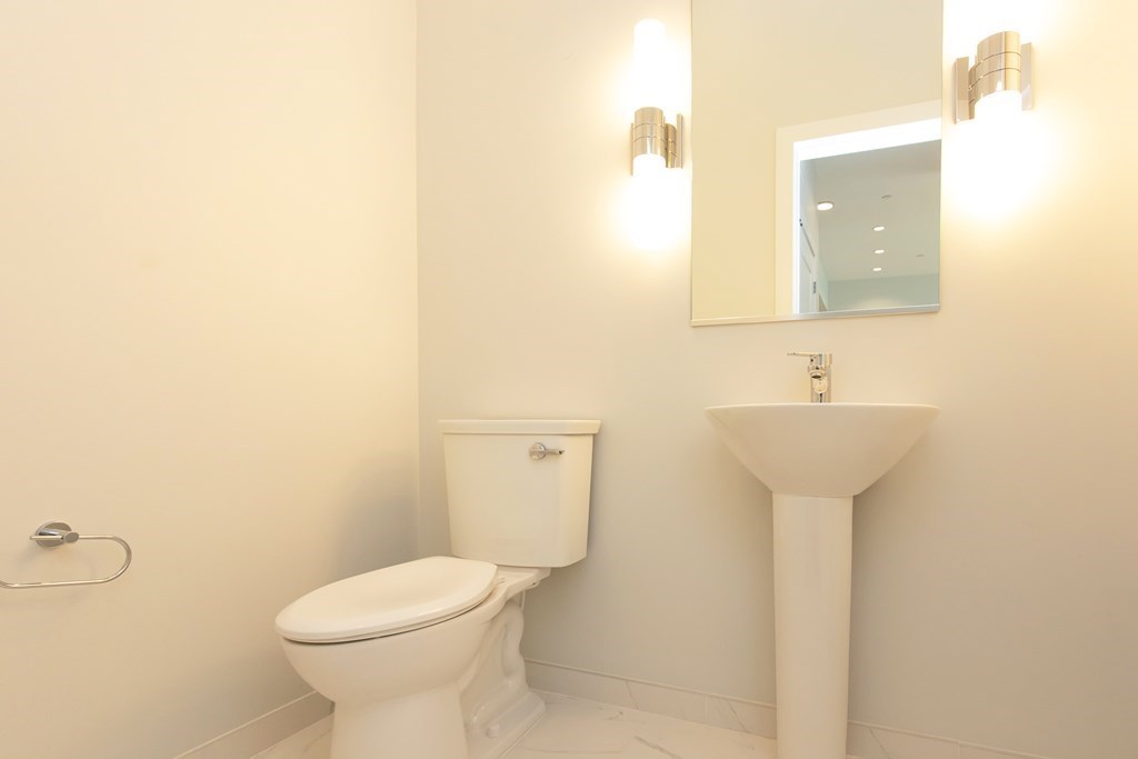10 Shipyard Drive, Unit 517 Hingham, MA 02043 - Photo 8 of 14 a bathroom with a toilet sink and mirror