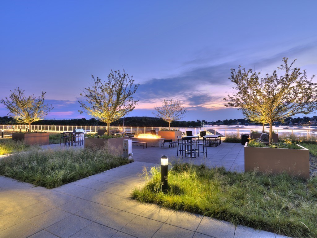 10 Shipyard Drive, Unit 517 Hingham, MA 02043 - Photo 9 of 14 a view of a swimming pool with a yard