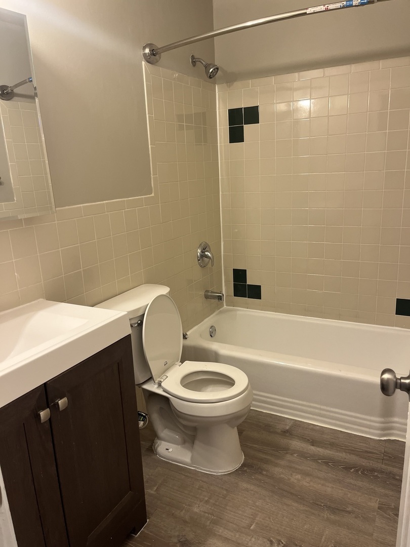 1340 North Main Street, Unit A7 Wheaton, IL 60187 - Photo 6 of 7 a bathroom with a sink a toilet and a bathtub