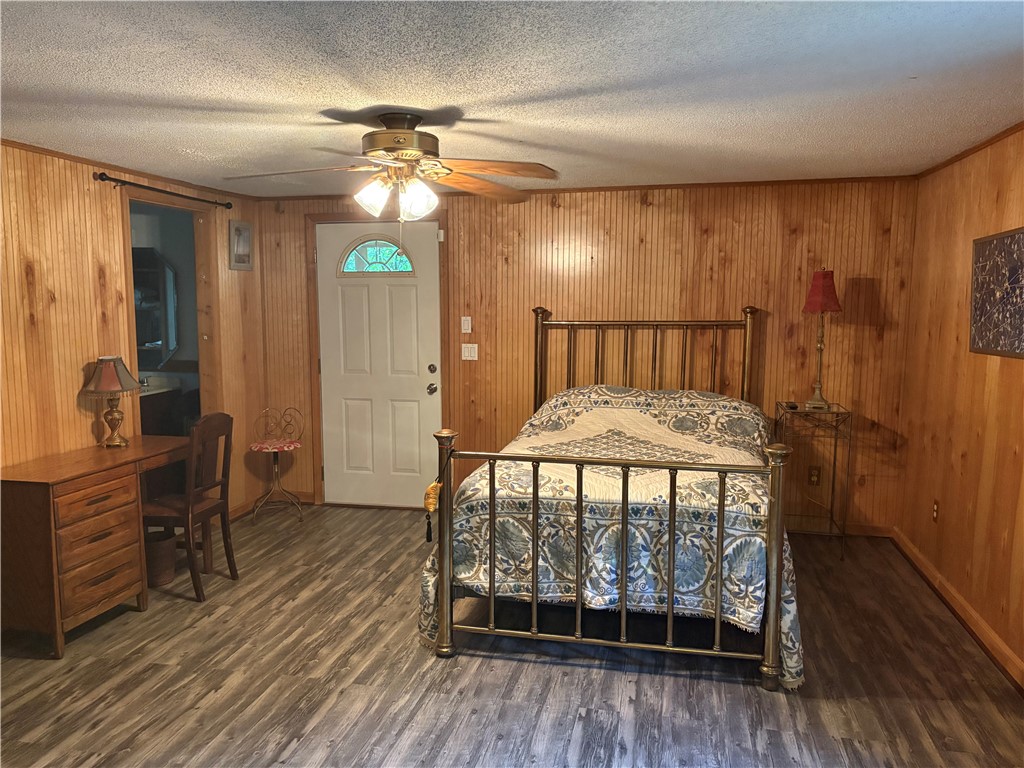 155 Hickory Ridge Mountain Rest, SC 29664 - Photo 14 of 21 Warm wood-paneled walls and durable laminate floors define this cozy bedroom retreat.