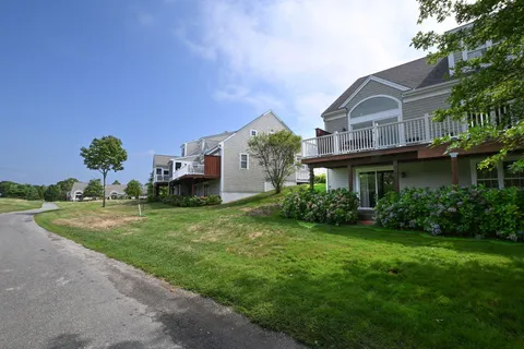 a view of a house with a small yard and plants