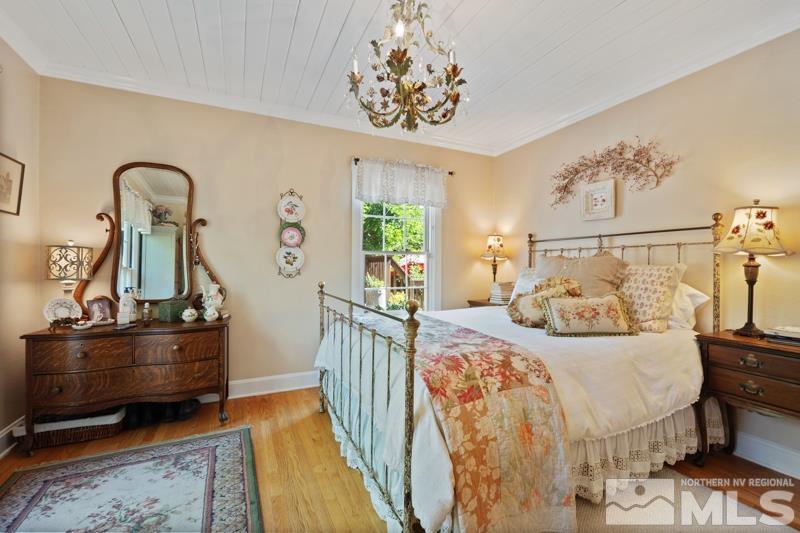 643 Manor Drive Reno, NV 89509 - Photo 18 of 37 a bedroom with bed and wooden floor