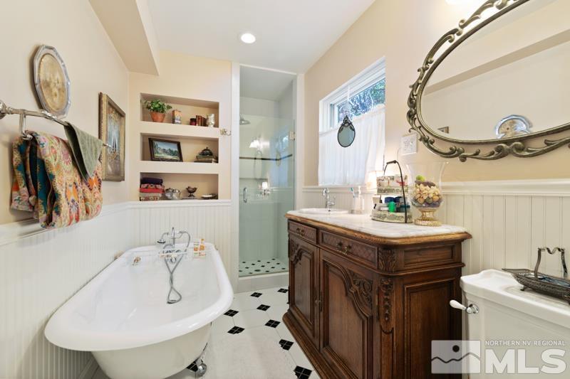 643 Manor Drive Reno, NV 89509 - Photo 19 of 37 a bathroom with a sink a mirror and a toilet