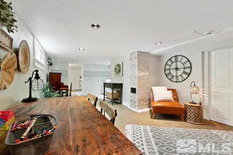 643 Manor Drive Reno, NV 89509 - Photo 23 of 37 a living room with furniture a clock and a fireplace