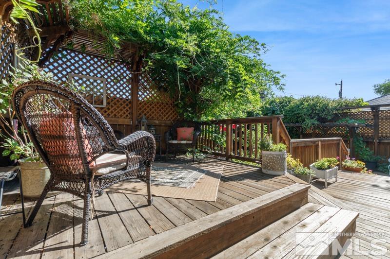 643 Manor Drive Reno, NV 89509 - Photo 36 of 37 a view of a patio with table and chairs with wooden floor and fence