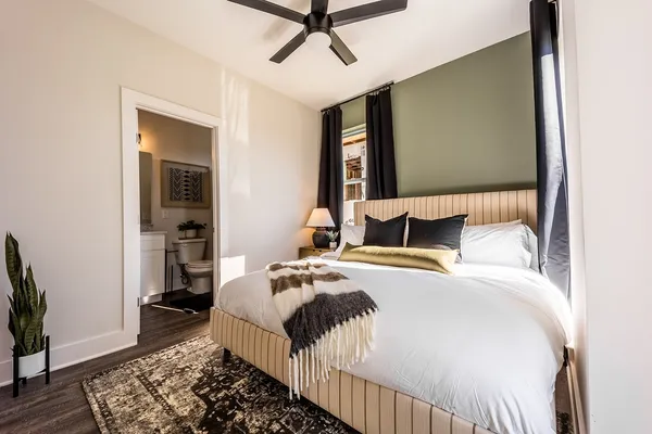a bedroom with a bed and wooden floor