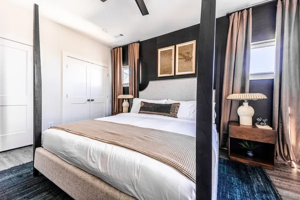 a bedroom with a bed and a flat screen tv
