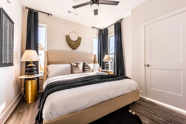 a bedroom with a bed and a chandelier