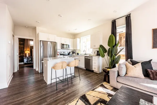 a kitchen with stainless steel appliances granite countertop a stove a sink and a refrigerator