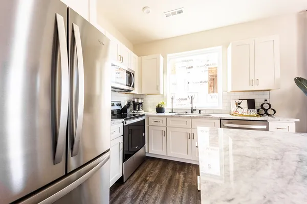a kitchen with a sink appliances and cabinets