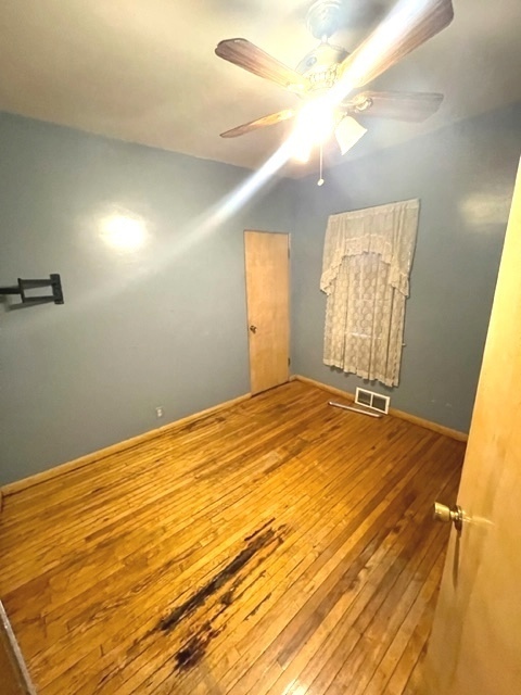 Undisclosed Address Chicago, IL 60639 - Photo 13 of 33 a view of empty room with window and wooden floor