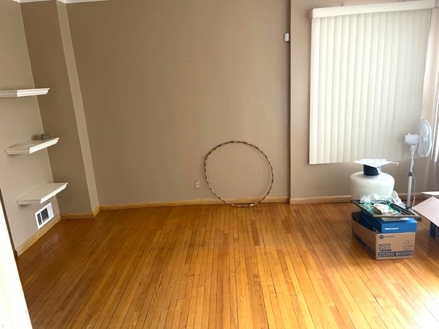 Undisclosed Address Chicago, IL 60639 - Photo 2 of 33 a view of room with window and wooden floor