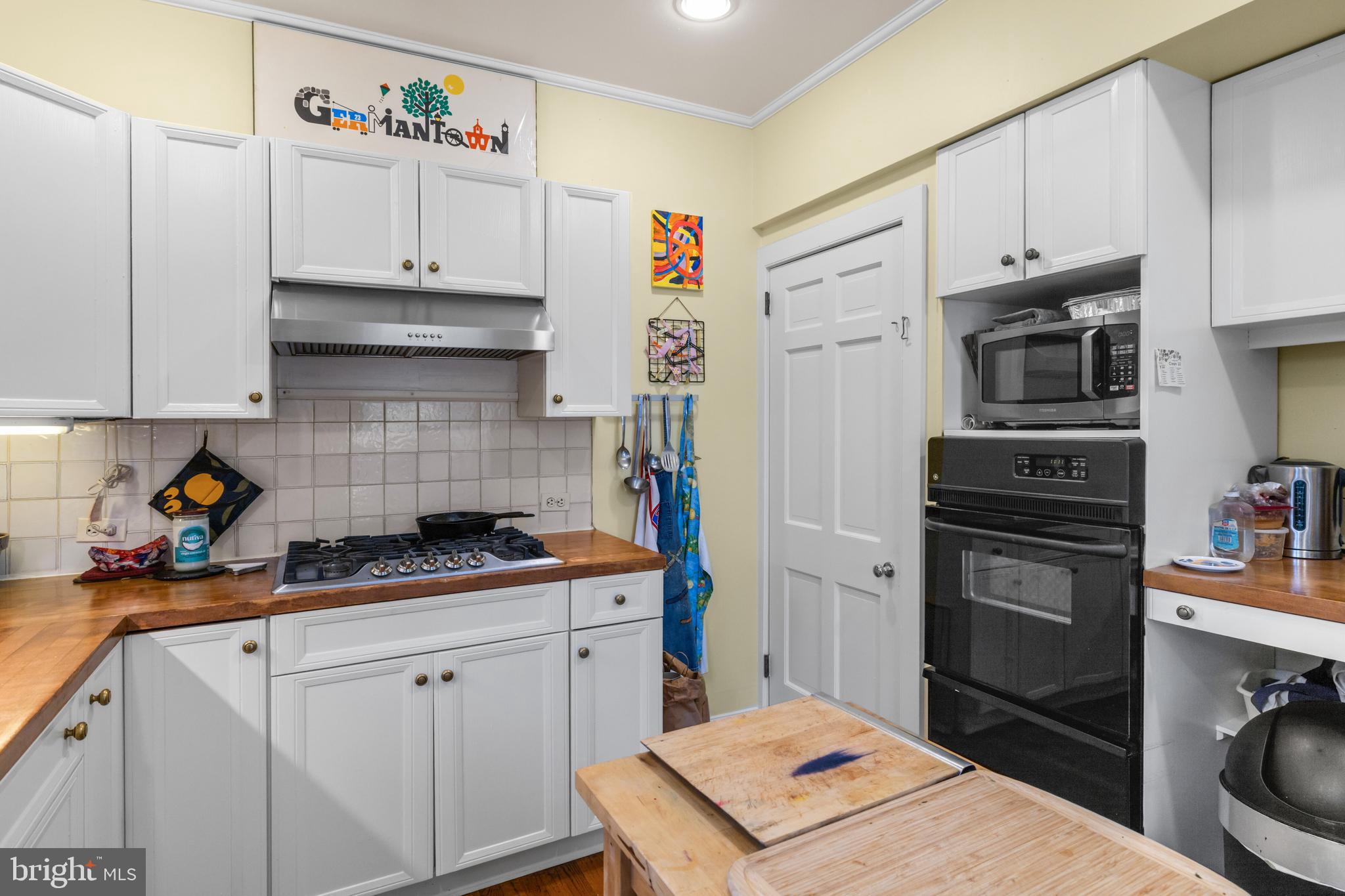 6020 Bridget Street Philadelphia, PA 19144 - Photo 12 of 43 a kitchen with stainless steel appliances a stove a sink and a refrigerator