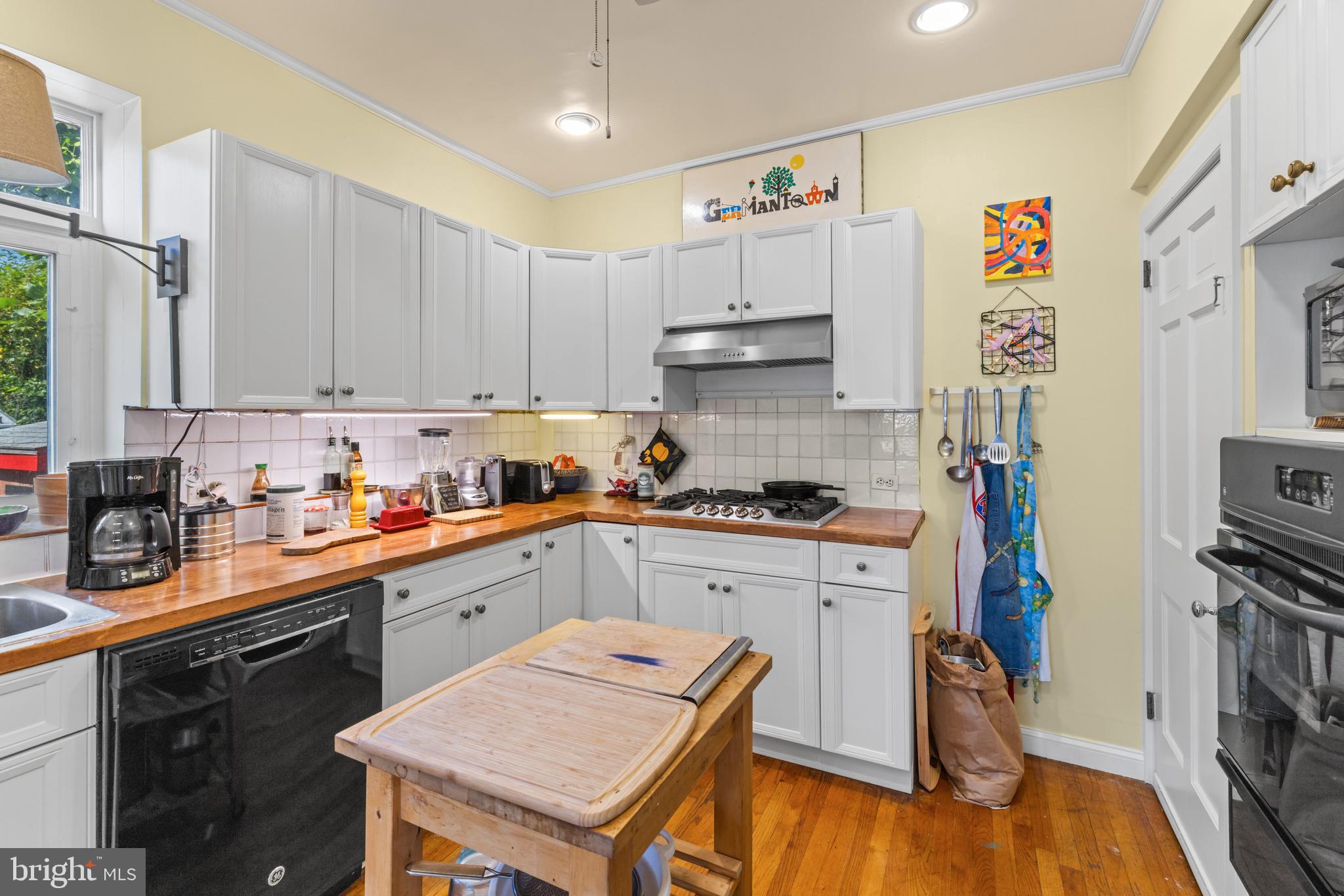 6020 Bridget Street Philadelphia, PA 19144 - Photo 13 of 43 a kitchen with stainless steel appliances sink cabinets and wooden floor