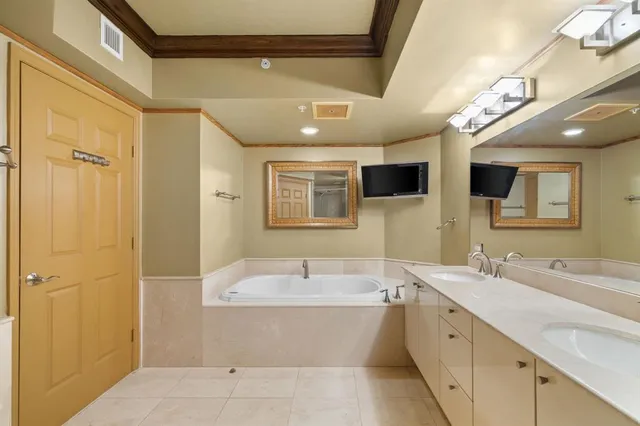 a bathroom with a bathtub shower sink double and mirror