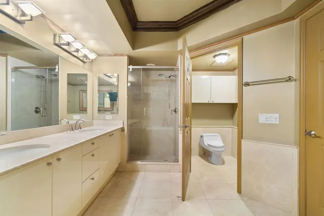 a spacious bathroom with a shower sink and mirror