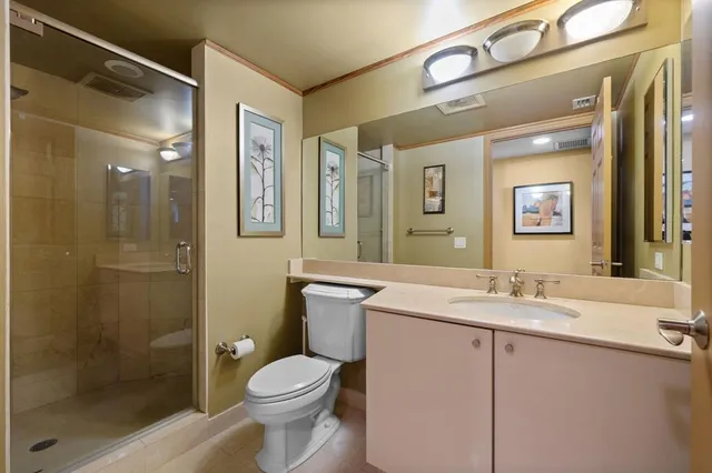 a bathroom with a granite countertop sink toilet and shower
