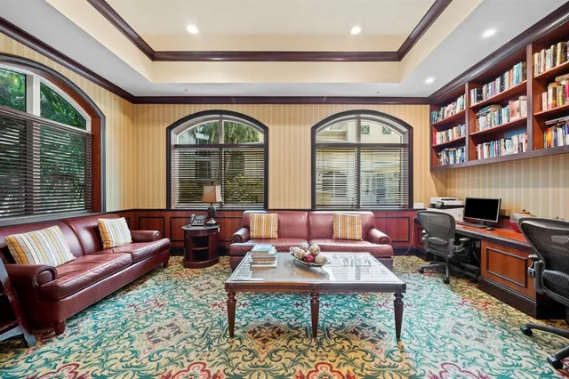 a living room with furniture fireplace and a large window