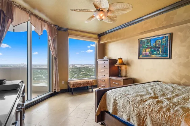 a bedroom with a bed and glass windows