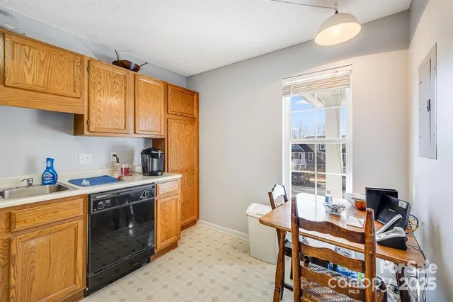 a kitchen with a stove a sink and cabinets