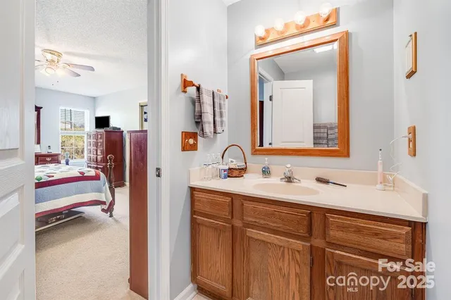a en suite bathroom with a sink and a mirror