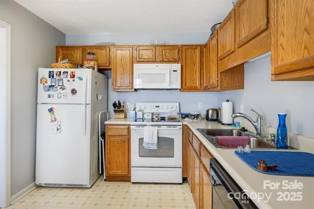a kitchen with a refrigerator and a sink
