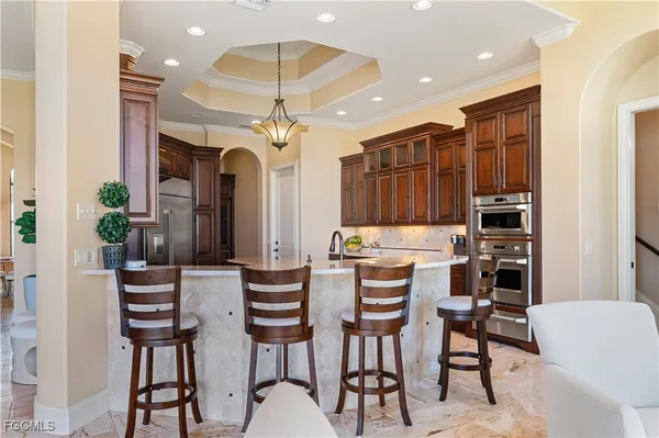 a view of a dining room with furniture and chandelier