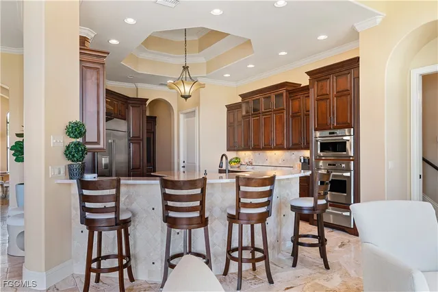 a view of a dining room with furniture and chandelier