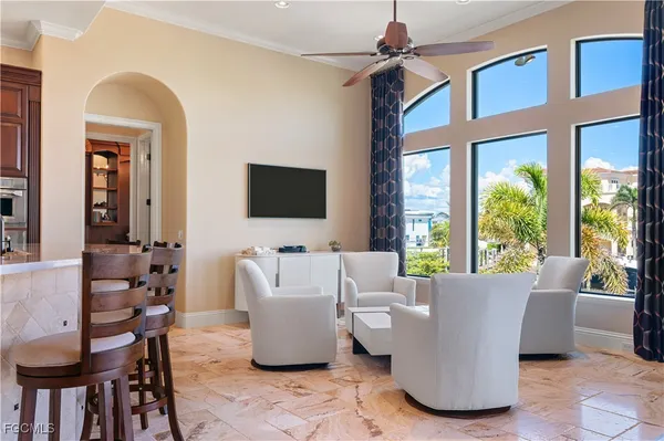 a living room with furniture a flat screen tv and a large window